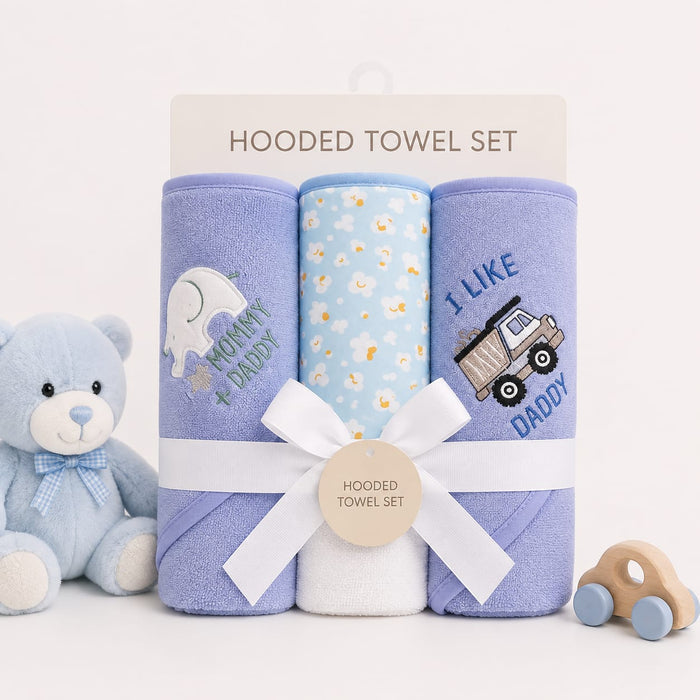 A baby hooded towel set displayed on a white background with a teddy bear on the left and a wooden toy car on the right. The set includes three rolled towels: a lavender one with a white elephant and 'KONNY PADDY' text, a light blue one with small yellow