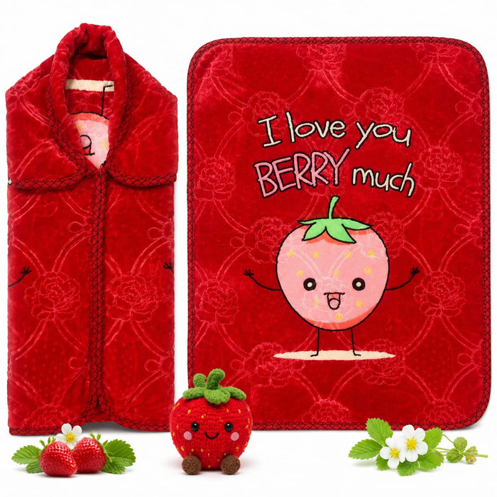 A red plush blanket set featuring a folded view on the left and a flat view on the right with the text 'I love you BERRY much' and a cute cartoon strawberry. A small plush strawberry toy and decorative fresh strawberries and flowers are placed in front on