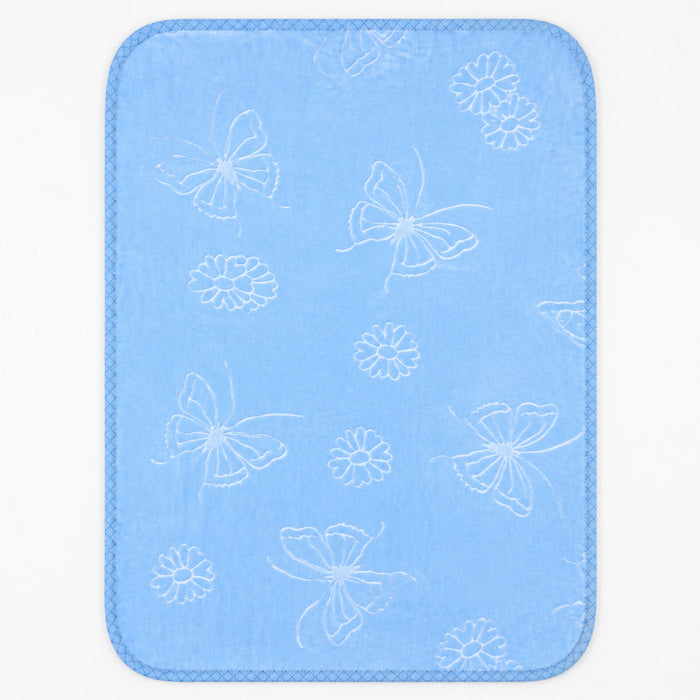 A rectangular baby blanket with rounded corners, featuring a light blue textured fabric with a white pattern of butterflies, flowers, and leaves, finished with a stitched border.