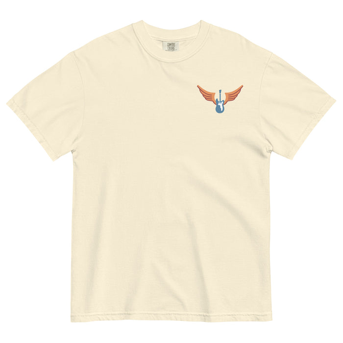 Cream colored Comfort Colors shirt with vintage-style text that reads 'Richard Valenzuela and his Flying Guitar' with an image of a blue guitar and orange wings from Sew Bonita in Corpus Christi, Texas