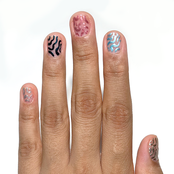 Sculpted Silver and metallic liners used for abstract accent nail art on a medium skin tone