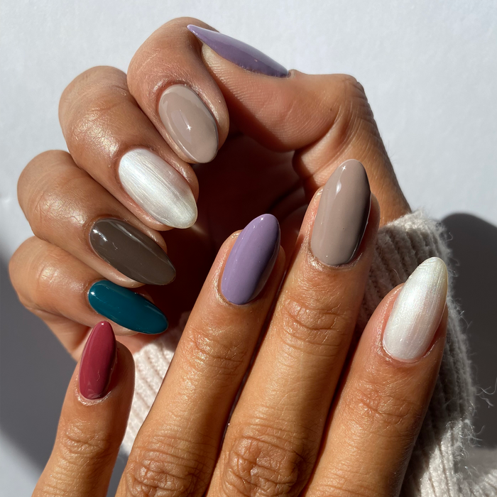 Sweater Weather teal, taupe, cream and plum mix-and-match manicure with a white sweater