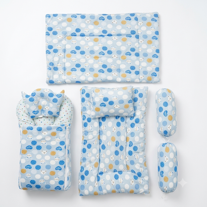 A 5-piece baby bedding set in light blue, featuring a polka dot pattern with white and yellow accents, including a mattress cover, changing pad, bassinet cover, and two cylindrical pillow covers, arranged on a white background.