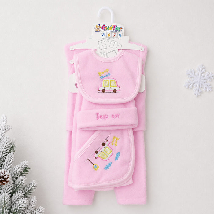 A pink baby clothing set hanging on a white hanger against a light background, featuring a bib, footed towel, and blanket with cute car and star embroidery. Decorative white snowflake and frosted pine branches appear at the edges.