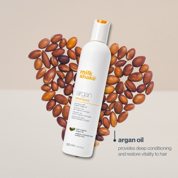 milk_shake Argan Shampoo bottle surrounded by argan seeds on a beige background