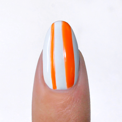 Atomic Orange liner used for neon orange vertical stripes on a sheer nude nail