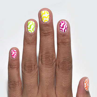Atomic Orange and neon liners used for squiggle nail art on a medium skin tone