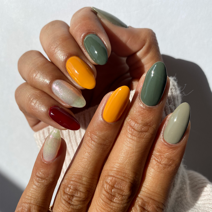 Autumn Leaves sage, mustard and burgundy mix-and-match manicure on a medium skin tone