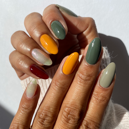 Autumn Leaves sage, mustard and burgundy mix-and-match manicure on a medium skin tone