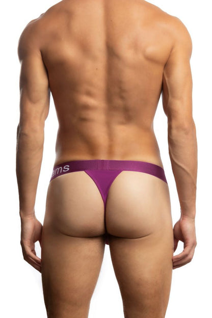 Shirtless man standing in front of a white background wearing a pair of Jack Adams Bamboo Thong in hollyhack (back view)
