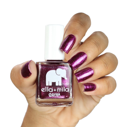 Bang Bang metallic purple-pink nail polish on a medium skin tone, hand holding the bottle