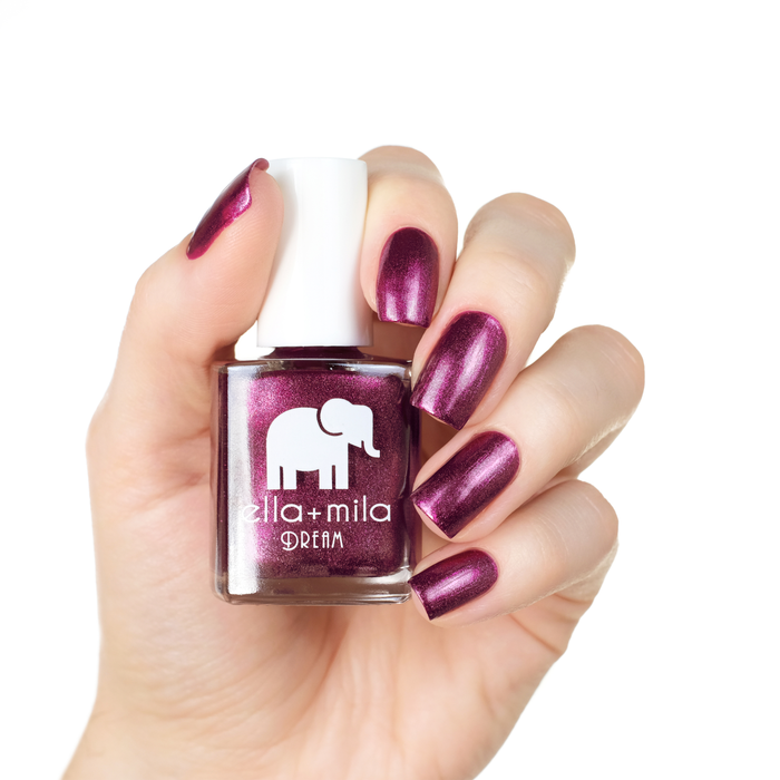 Bang Bang metallic magenta nail polish manicure on a light skin tone with the bottle