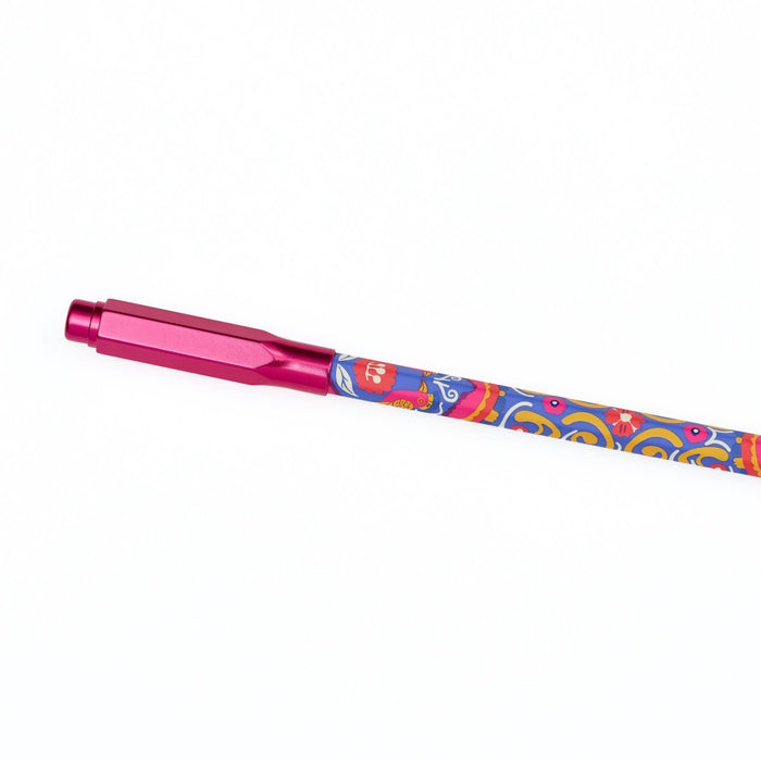 A metallic pink pencil point guard attached to the end of a colorful patterned pencil featuring blue, orange, and yellow swirls, shown diagonally on a plain white background.