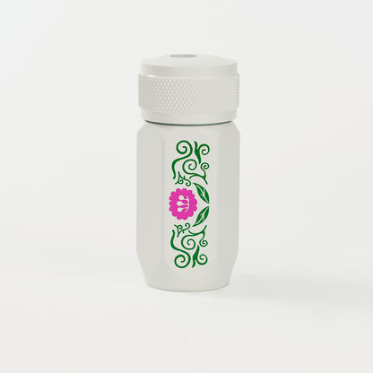 A white Blackwing one-step sharpener  featuring a green vine pattern and a pink flower graphic on the side.