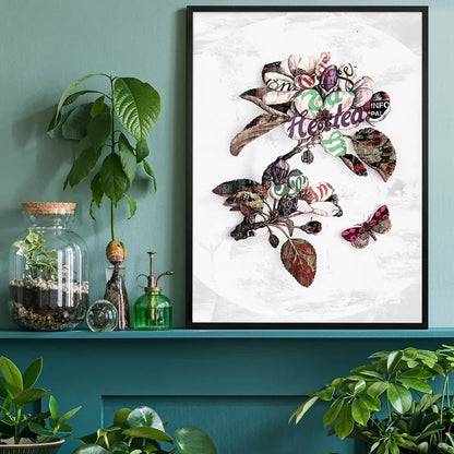 Framed botanical floral typography print on white, featuring a butterfly, displayed on a teal shelf with plants.