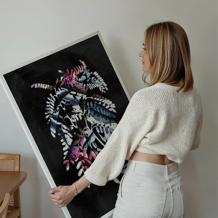 Woman holding a large, unframed Botanical 8 Floral Print with vibrant, contemporary paint strokes on a dark background.