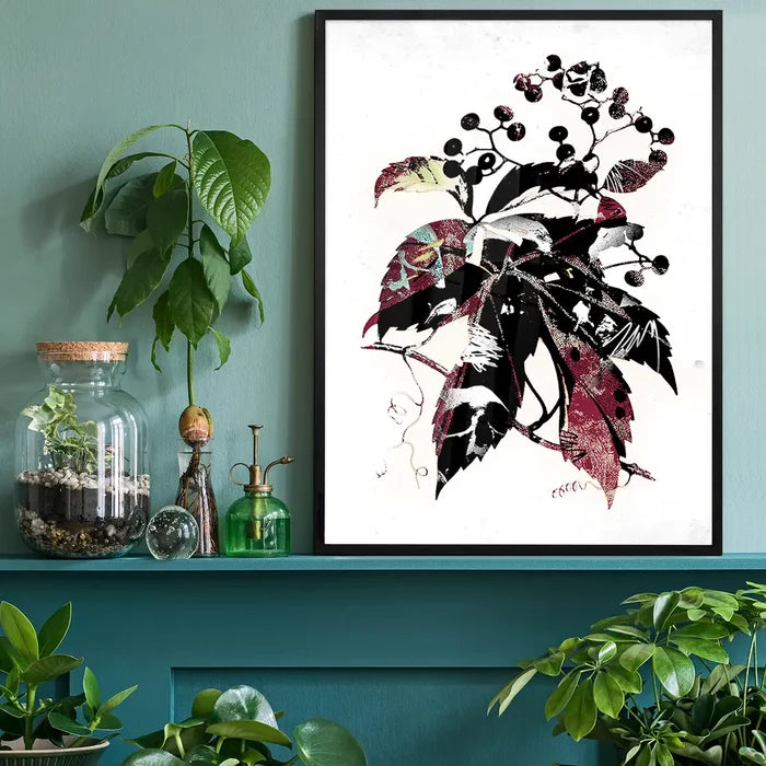 Framed botanical leaves print with black, red, and white graffiti-style details on a white background.