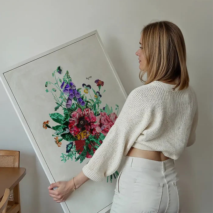 Woman holding a large unframed Botanical Streetart White Print with colorful floral and street art elements.
