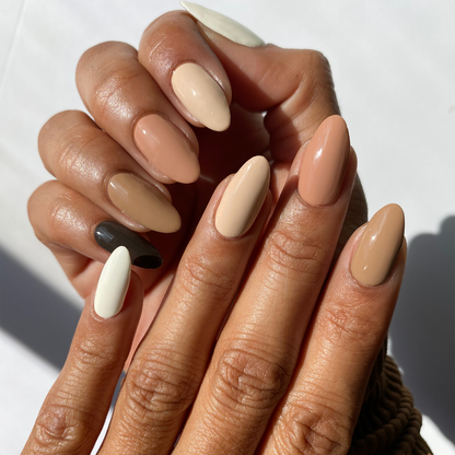 Cocoa Kisses cream, tan and dark brown mix-and-match manicure on a medium skin tone