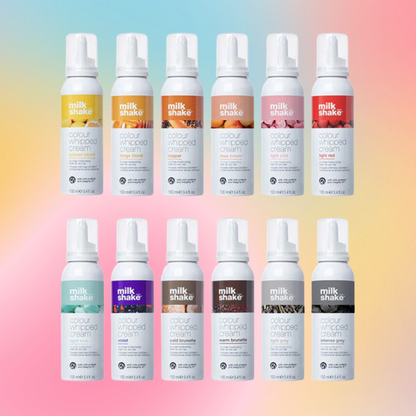 Multiple bottles of milk_shake  hair products on a gradient background