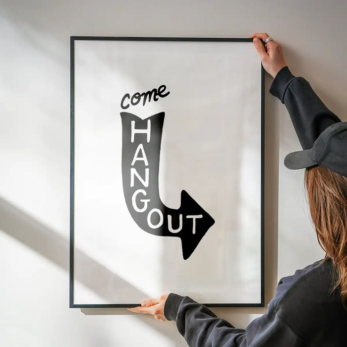 Black framed "Come Hang Out" typographic print with a downward arrow design on white archival art paper.