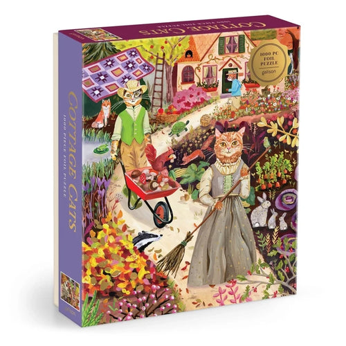 Colorful puzzle box featuring an illustrated garden scene by Anja Riebensahm, with two anthropomorphic cats in vintage attire among flowers and a cottage. The box label reads Galison Cottage Cats | 1,000 Piece Jigsaw Puzzle.
