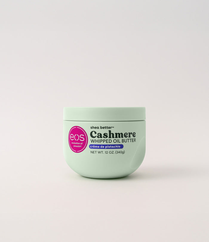 Green jar of eos Cashmere Whipped Oil Butter on a light gray background