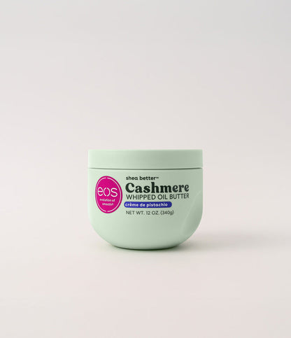Green jar of eos Cashmere Whipped Oil Butter on a light gray background