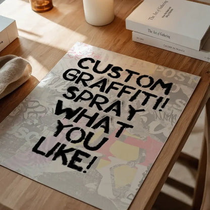 Custom graffiti stencil print with "CUSTOM GRAFFITI! SPRAY WHAT YOU LIKE!" in black spray paint on a light background.
