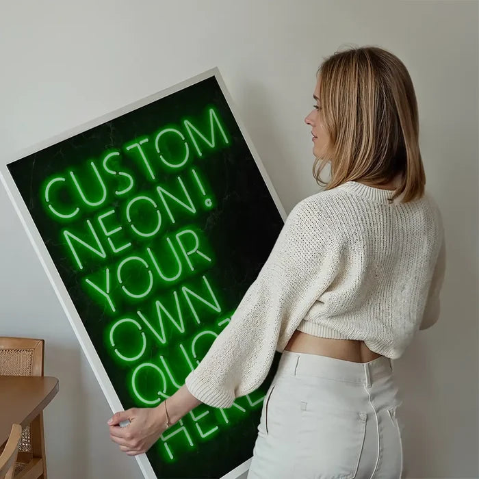Woman holding a large framed custom green neon quote sign print with "CUSTOM NEON! YOUR OWN QUOTE HERE" text.