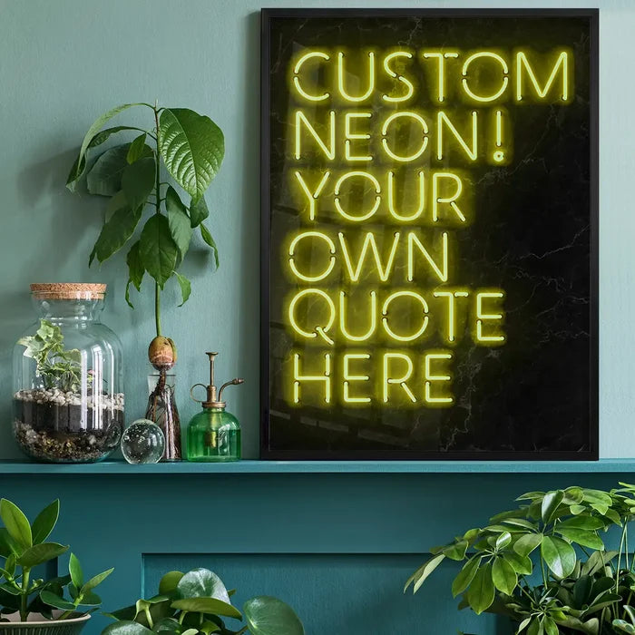 Yellow custom neon sign print on black background, framed, displayed on a teal shelf with plants.