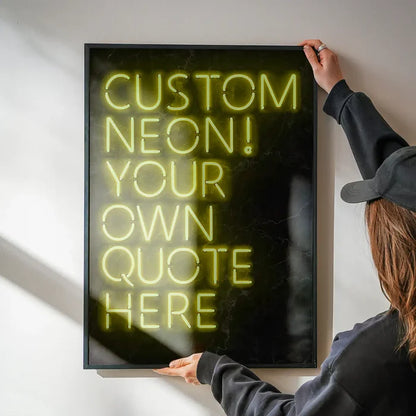 Person holding a framed custom yellow neon sign print with "CUSTOM NEON! YOUR OWN QUOTE HERE" text.