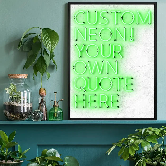 Black-framed custom quote neon print with bright green glowing text on a textured white background, styled on a shelf.