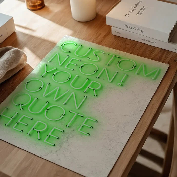 Custom green neon print on gloss paper, displaying "CUSTOM NEON! YOUR OWN QUOTE HERE" on a wooden desk.