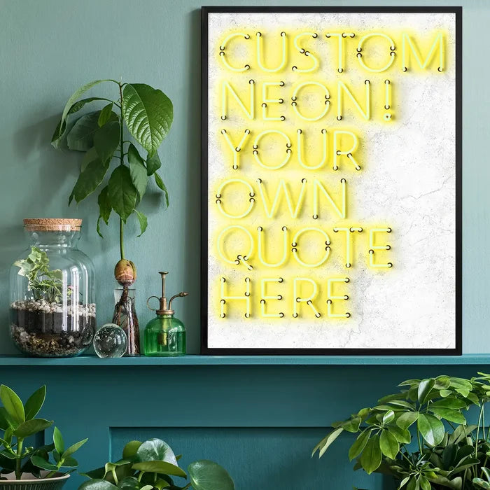 Black framed print with yellow custom neon-style text "CUSTOM NEON! YOUR OWN QUOTE HERE" on a white textured background.