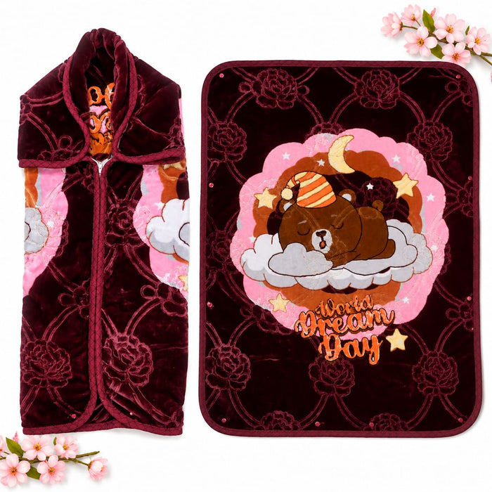 A plush fleece blanket and matching zippered pouch shown on a white background with decorative pink flowers. The blanket features a dark burgundy floral pattern, a central pink cloud design with a sleeping brown bear on clouds and stars, and the words 'Wo