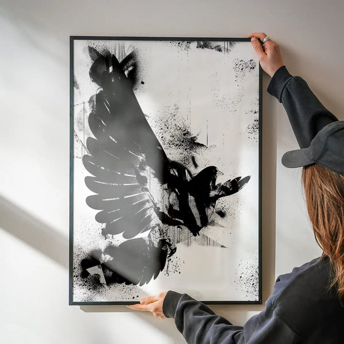 Black and white abstract graffiti print of a dove on thick art paper, held by hands.