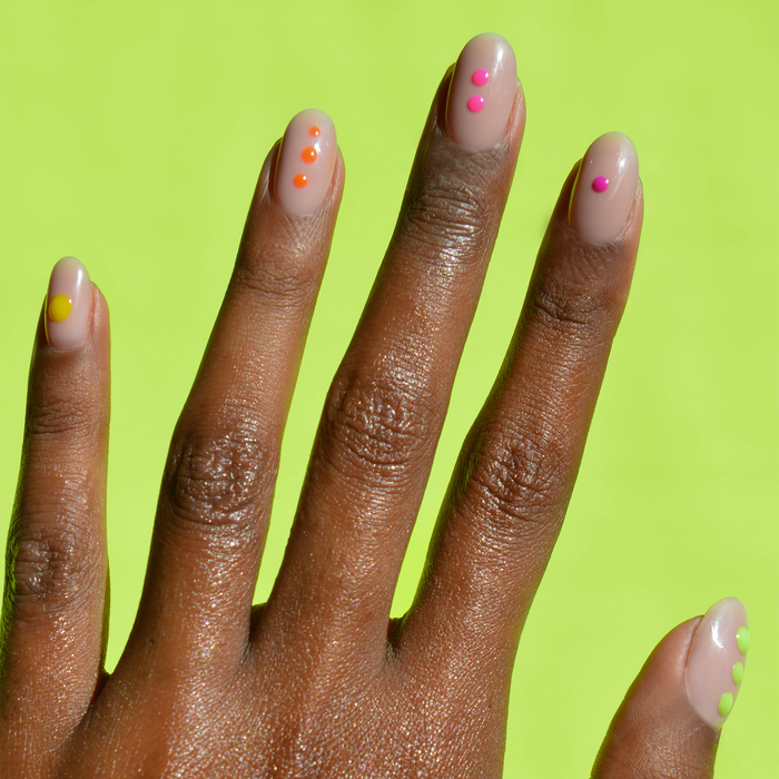 Electric Lime liner with neon dot nail art on a deep skin tone, lime green background