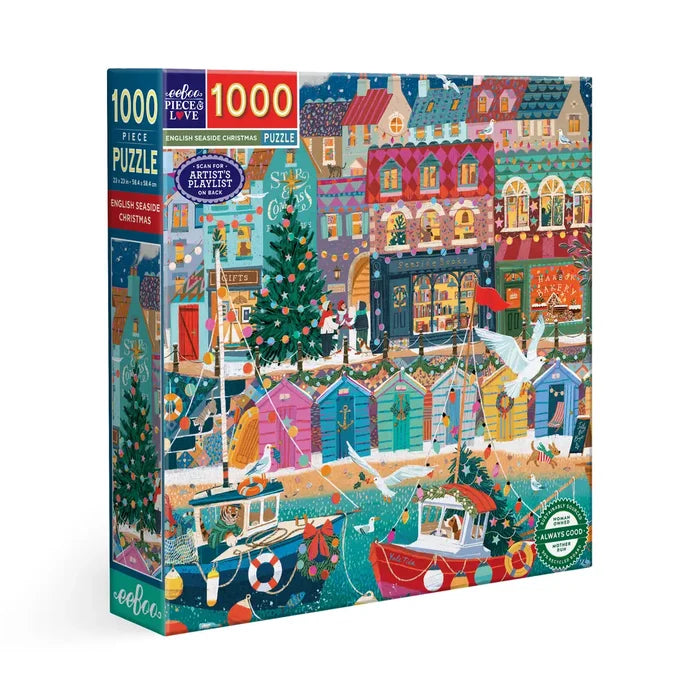 The eeBoo English Seaside Christmas 1,000 Piece Jigsaw Puzzle features a vibrant holiday scene with boats, decorated homes, Christmas trees, lights, and ornaments by the sea.