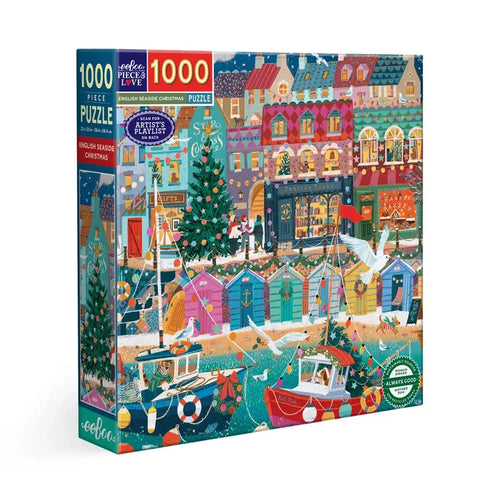The eeBoo English Seaside Christmas 1,000 Piece Jigsaw Puzzle features a vibrant holiday scene with boats, decorated homes, Christmas trees, lights, and ornaments by the sea.
