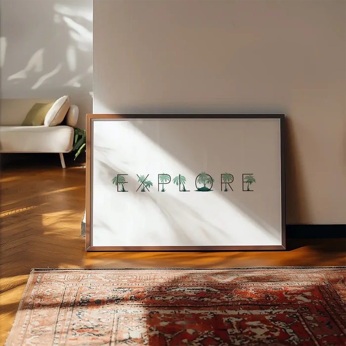 Framed "EXPLORE" typographic print with palm tree letters on white archival paper, leaning against a wall.
