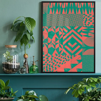 Abstract geometric art print with pink and green segments in a black frame, on a teal shelf.