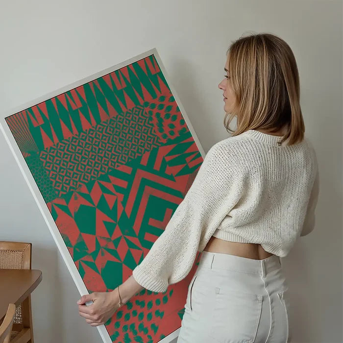 Woman holding a framed Geometric Segments Pink & Green abstract art print on archival paper.