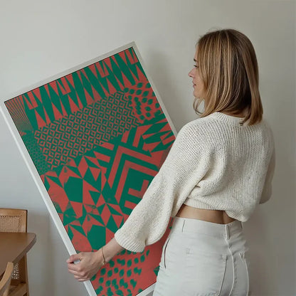 Woman holding a framed Geometric Segments Pink & Green abstract art print on archival paper.