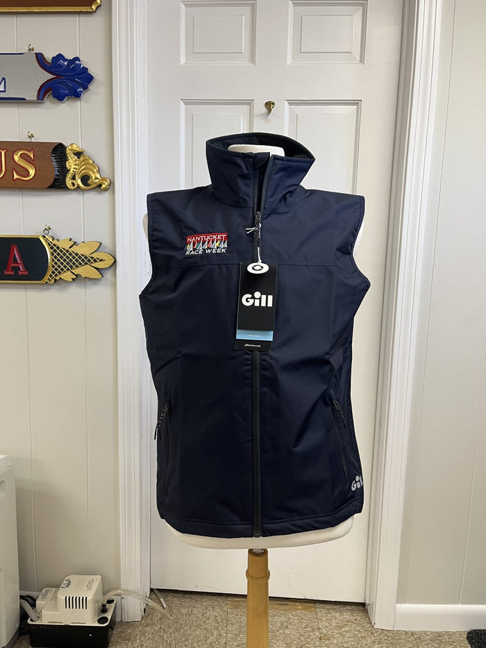 Navy blue gilet on a mannequin with a white door and decorative items in the background