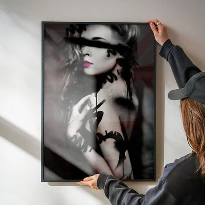 Framed graffiti art print of a model with black spray paint marks and vibrant pink lips.