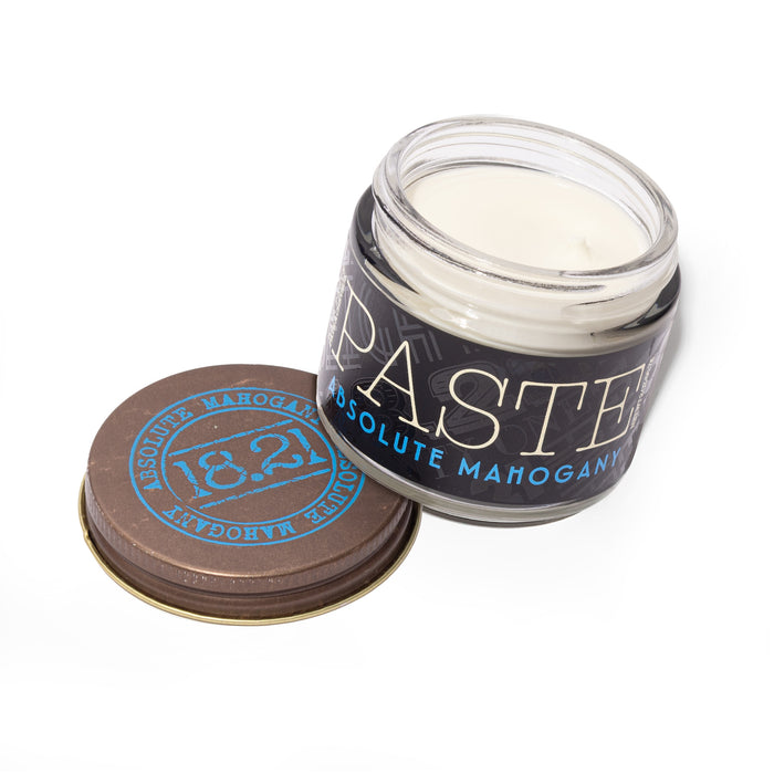 Jar of paste with a brown lid on a white background