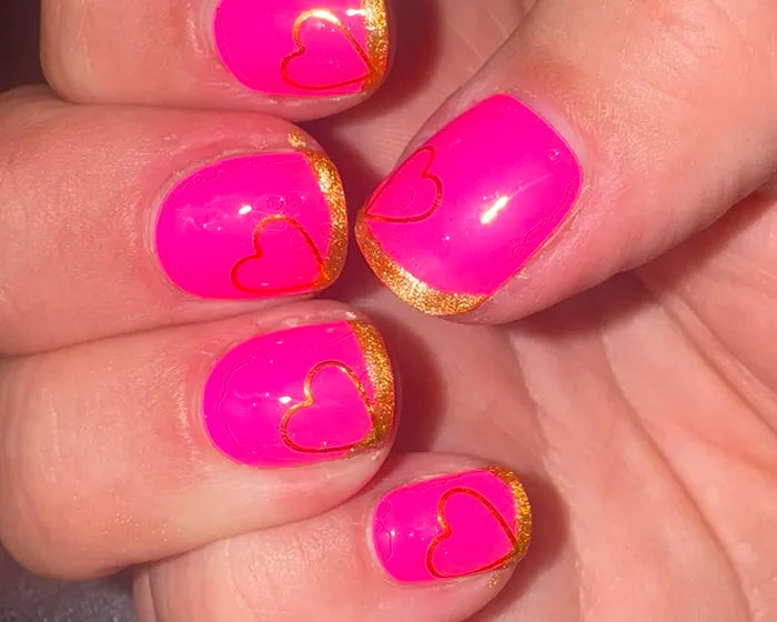Close-up of the Heartbreaker gold heart accent nails