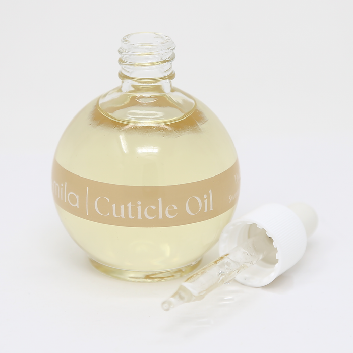 Vanilla Dream cuticle oil round bottle with the dropper cap beside it