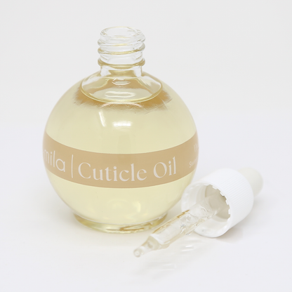 Vanilla Dream cuticle oil round bottle with the dropper cap beside it